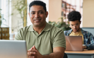 Decorative image showing male-presenting person studying online.